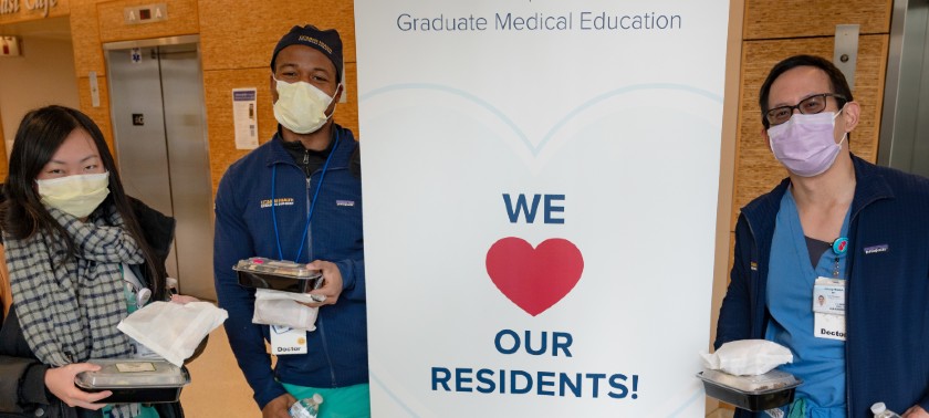 Residents standing next to sign during residency appreciation week