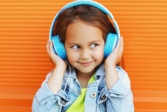 happy girl listening to music on her headphones