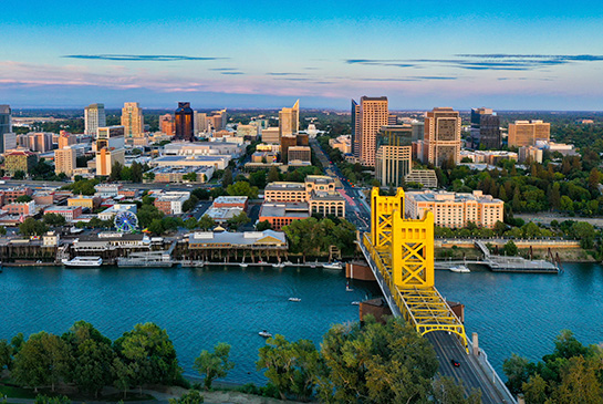 Birds eye view of Sacramento downtown with Capitol City Bridge in bright yellow.