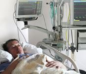 patient in hospital bed with monitors