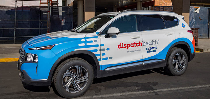 Blue and White car with “DispatchHealth” and “UC Davis Health” written on the door