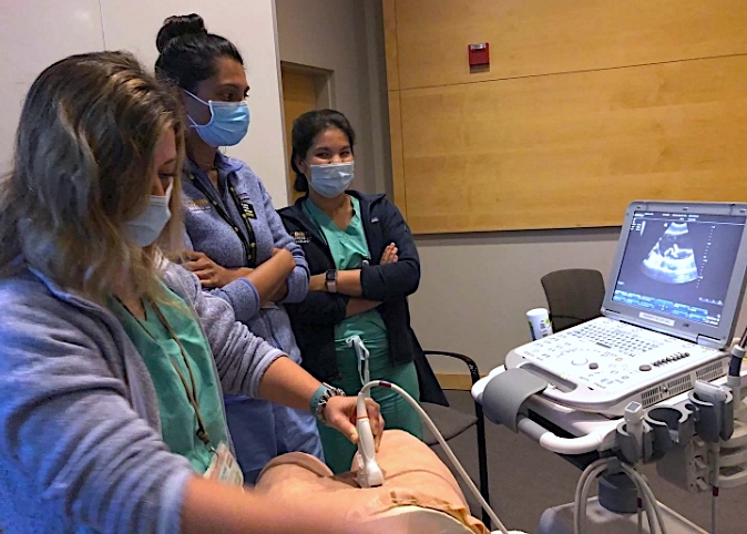 fellows training on ultrasound machine