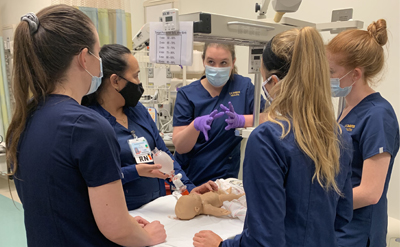 Nurses learning via an infant simulation mannequin. (C) UC Davis Regents.